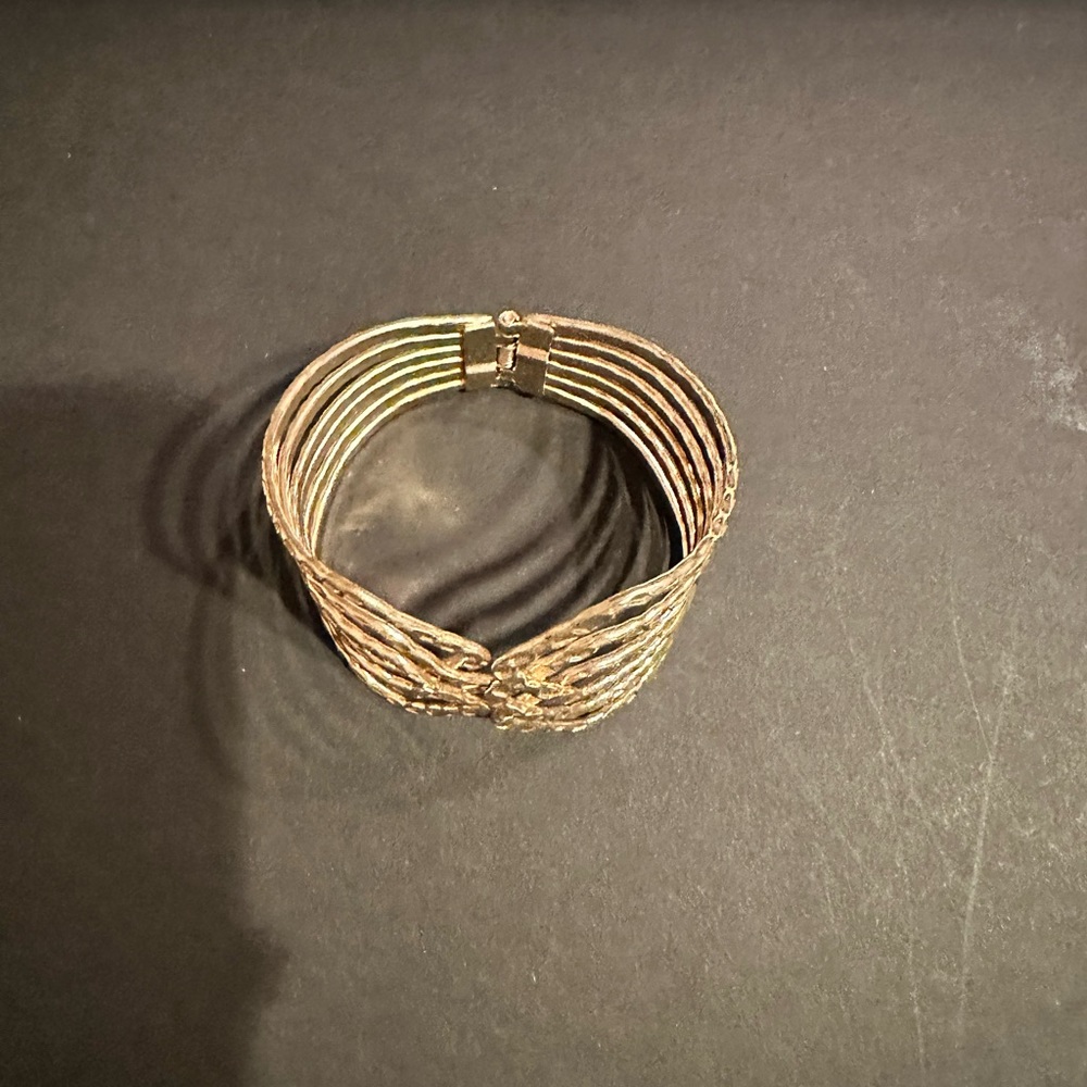 Gold tone spring cuff bracelet. Excellent condition.